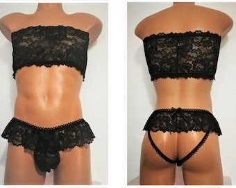 May include: A black lace lingerie set, comprising a strapless top and low-rise briefs with a frilled edge. The set is displayed on a mannequin, highlighting the delicate floral pattern of the lace.