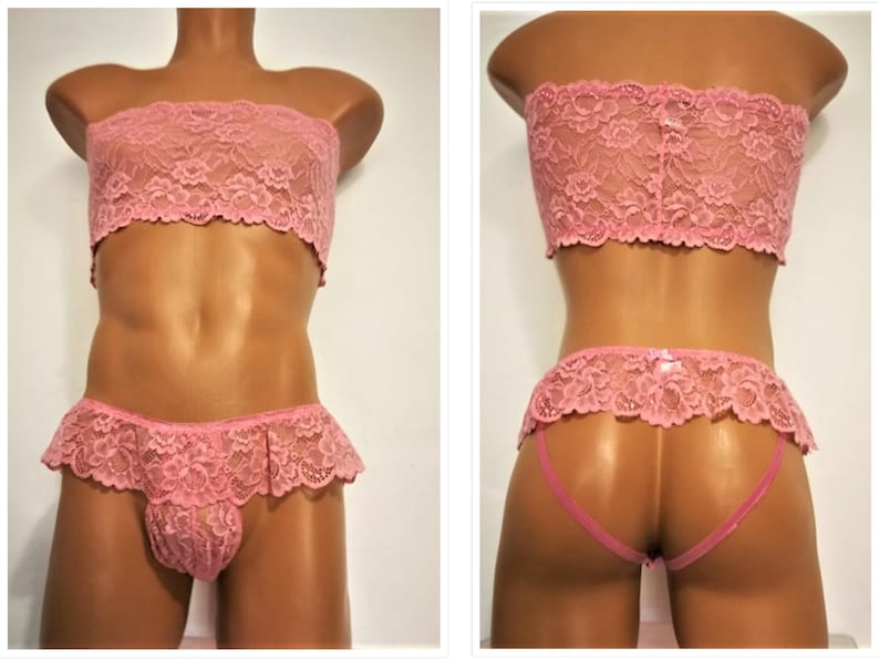 May include: Pink lace lingerie set with a strapless bra and a ruffled panty. The set is made of delicate lace and has a feminine design.