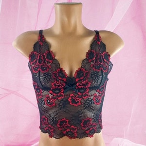 May include: Black lace lingerie top with red floral embroidery.