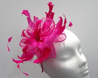 Flower effect fuschia pink fascinator with feathers for weddings, race days or special occasions.