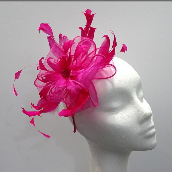 Flower effect fuschia pink fascinator with feathers for weddings, race days or special occasions.