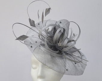 hand made metallic silver sinamay saucer hat with sculptured now detail.