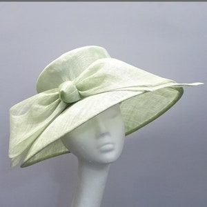 Ladies occasion hat in pale green with bow for weddings, derby day, race days.