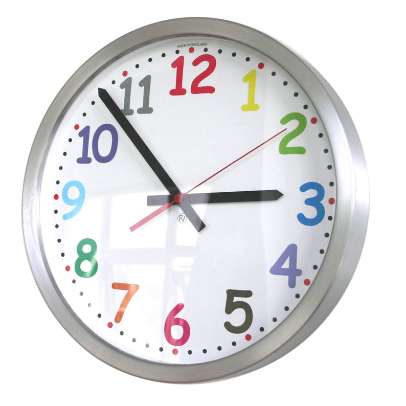 May include: A silver round clock with a white face and black hands. The numbers 1 through 12 are in a rainbow of colors. The clock is made in England.