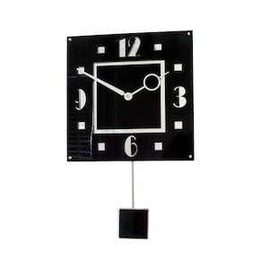 May include: A black square clock with white numbers and hands. The clock has a pendulum and is hanging on a white wall.