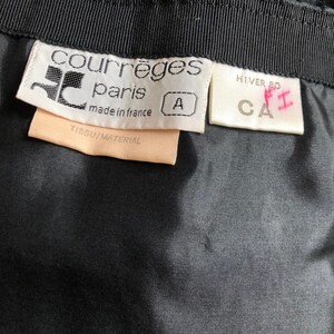 May include: A white tag with black text that reads "Courr&egrave;ges Paris made in France" and a size "A" tag. A white tag with black text that reads "HIVER 80 CA" and a pink handwritten "F1" tag.