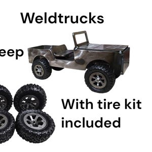 May include: A metal Jeep toy with a tire kit included. The toy Jeep is silver and has black tires. The text "Weldtrucks" and "Jeep" are above the toy, and "With tire kit included" is below.