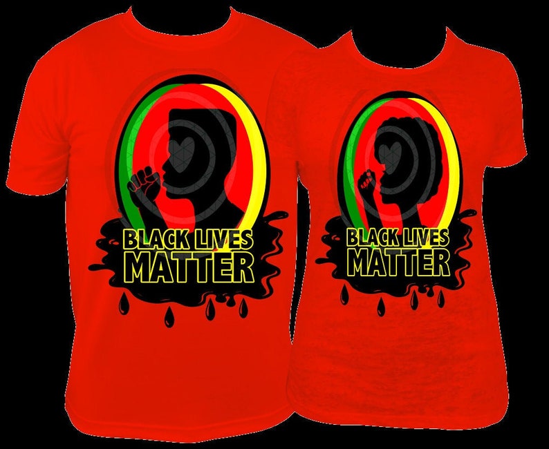 Pu&ograve; includere: Due magliette rosse con le parole "BLACK LIVES MATTER" in giallo e nero. Ogni maglietta presenta una silhouette nera di una persona con il pugno alzato all'interno di un cerchio con strisce verdi, rosse e gialle.