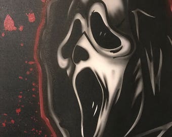 May include: A black and white painting of the Ghostface mask from the Scream horror film series. The mask is white with black eye sockets and a wide open mouth. Red paint splatters and a red outline surround the mask.
