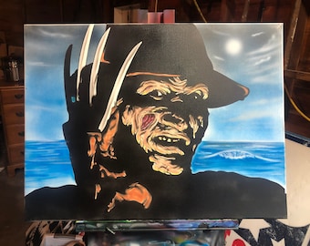 May include: A painting of a horror movie character with a disfigured face and a black hat. The character is holding a weapon with sharp blades. The background is a blue ocean with a white moon in the sky.