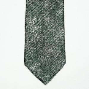 May include: A dark green necktie with a floral pattern. The tie features a repeating design of white floral outlines against a textured background. The tie is displayed against a white background.