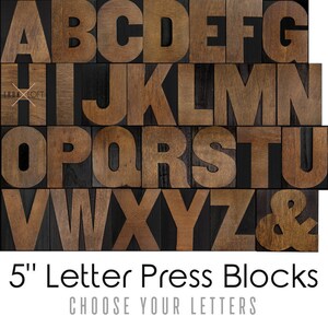 May include: Wooden letterpress blocks in uppercase letters A through Z and an ampersand. The blocks are 5 inches tall and have a dark brown wood finish.  "5" Letter Press Blocks CHOOSE YOUR LETTERS