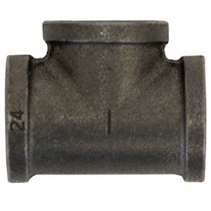 May include: A black iron T-fitting with a threaded design. The fitting has three openings and is marked with the number "24" on one side. The surface has a textured appearance.