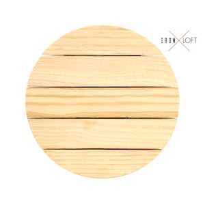May include: A round wooden coaster with a natural wood finish. The coaster has five horizontal slats.