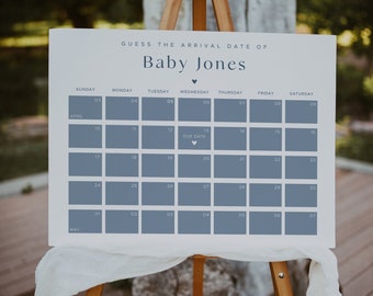 May include: A white sign with blue text and a calendar for guessing the arrival date of a baby. The sign says "Guess the arrival date of Baby Jones" and has a calendar with the month of April and the beginning of May. The due date is marked with a heart.