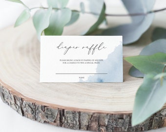 May include: A white card with blue watercolor accents reads "diaper raffle" and includes the text "Please bring a pack of diapers of any size for a chance to win a special prize." There is a blank line for a name.