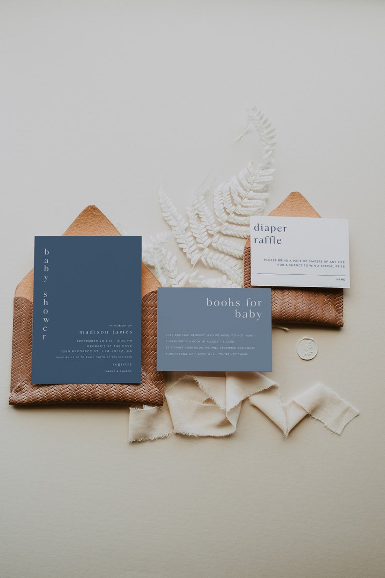 May include: A blue invitation card with white text for a baby shower in honor of Madison James. The invitation includes the date, time, and location of the event. There are also two smaller cards, one for a diaper raffle and one for a book drive for the baby.