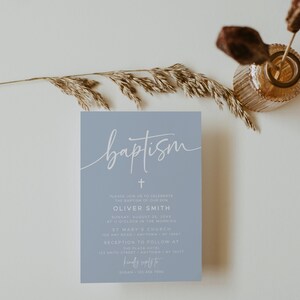 May include: A light blue baptism invitation with white text. The invitation reads "baptism" in a cursive font, followed by a cross and the text "Please join us to celebrate the baptism of our son Oliver Smith Sunday, August 25, 20XX at 11 o'clock in the morning St Mary's Church 100 Any Road, Anytown, NY 10967 Reception to follow at The Plaza Hotel 123 Smith Street, Anytown, NY 10273 Kindly reply to Susan - 123 456 7000"