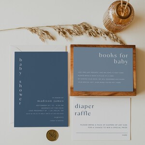 May include: A blue and white baby shower invitation with the text "baby shower" in vertical script. The invitation includes the name "madison james", the date and time of the event, and the location. The invitation also includes a request for guests to bring a book in place of a card, and a diaper raffle.