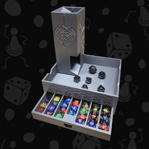 May include: A grey, 3D printed dice tower with a Celtic knot design. The tower has a compartment for dice and a drawer with compartments for storing dice. The drawer is open and filled with colourful dice.