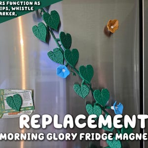 Może przedstawiać: Zielone magnesy w kształcie liści w kształcie serca z niebieskimi i pomarańczowymi magnesami w kształcie kwiatów na lodówce ze stali nierdzewnej. Wyświetlany jest tekst "REPLACEMENTS MORNING GLORY FRIDGE MAGNETS".