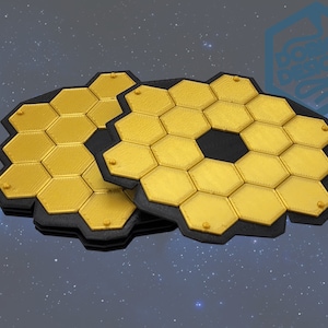 May include: Three gold-colored, honeycomb-shaped objects with black borders, resembling the James Webb Space Telescope's primary mirror segments. The objects are arranged against a starry background, suggesting a space or science theme.