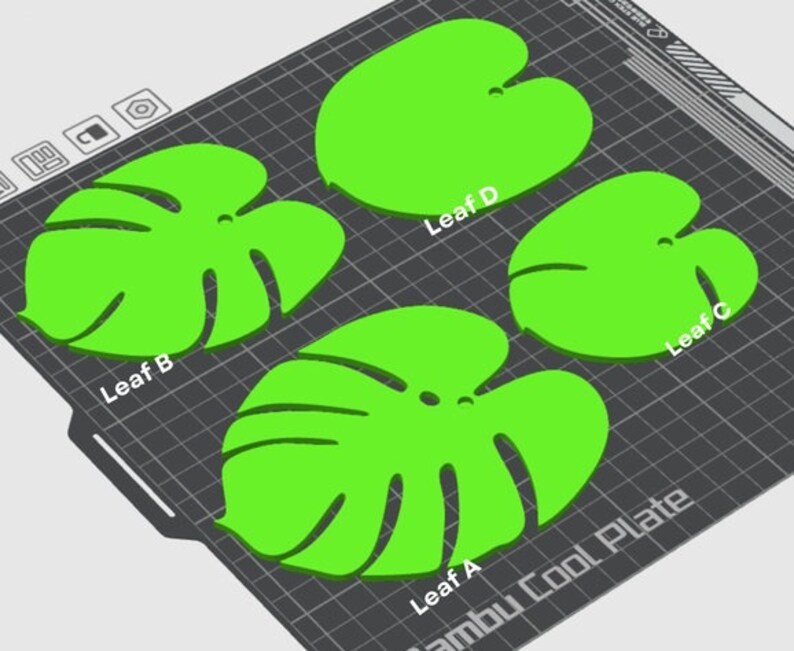 May include: Four green leaf-shaped stencils on a black grid surface. The stencils are labeled Leaf A, Leaf B, Leaf C, and Leaf D. The text "Bambu Cool Plate" is visible in the lower right corner.