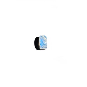 May include: A small, iridescent blue and white stone with a marbled pattern.