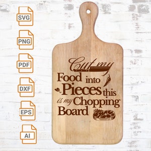 以下が含まれることがあります： 「Cut my Food into Pieces this is my Chopping Board」という文字が刻まれた木製のまな板。まな板には持ち手があり、ナイフ、唐辛子、肉片で飾られています。