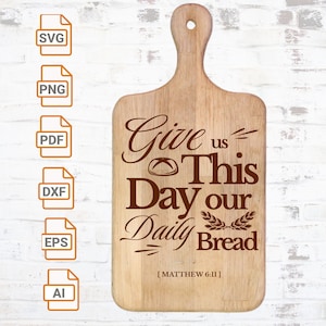 May include: A wooden cutting board with the text "Give us This Day our Daily Bread [MATTHEW 6:11]" engraved on it. The text is in a brown font and the board is light brown.