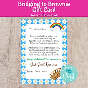May include: A blue and white gift card with a daisy border and a rainbow illustration. The card reads "Bridging to Brownie Gift Card" and includes a poem about joining Girl Scouts. The card is personalized with names.