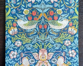 May include: A blue and green patterned fabric with a repeating design of birds, flowers, and leaves. The fabric has a vintage aesthetic and is perfect for crafting projects.