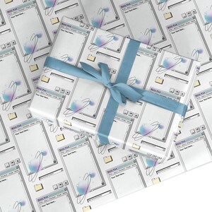May include: White wrapping paper with a repeating pattern of a computer window with the text "Note Pad" and the words "Your Text Here". The window has a blue and purple gradient orb with a white ring around it. The paper is wrapped around a gift box with a blue ribbon.