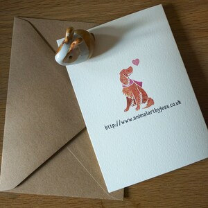 May include: A white card with a brown dog illustration and a pink heart. The text on the card reads "http://www.animalartbyjess.co.uk".