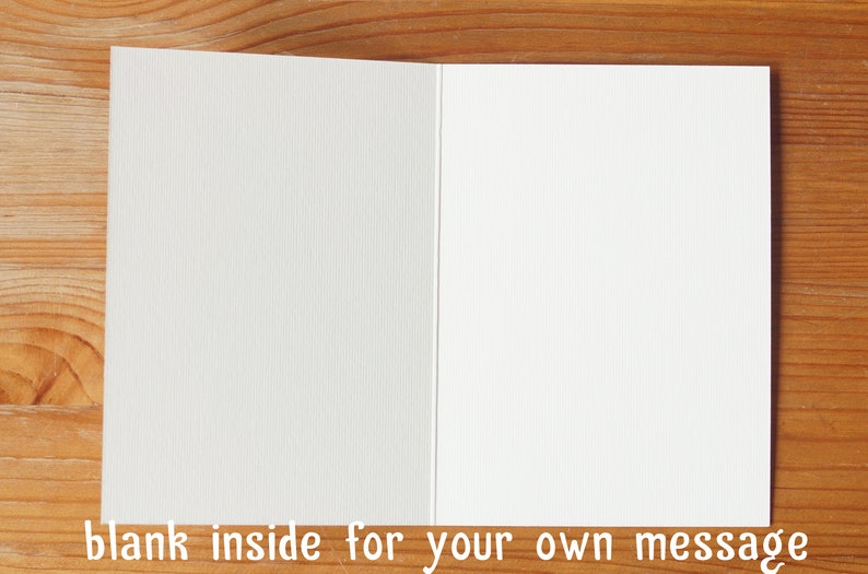 May include: Blank white card with a textured surface. The card is folded in half and is ready for a message.