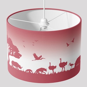 May include: A red and white ombre lampshade featuring a silhouette of an African savanna scene, including a tree, birds, a rhino, an ostrich, a hyena, and a bird.