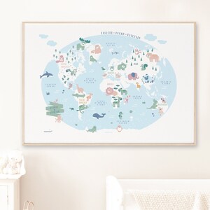 May include: A light blue world map with a white border, featuring illustrated animals from different continents. The map is framed in a light wood frame and is hanging on a white wall.