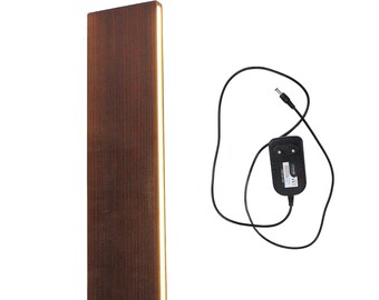 May include: A brown wooden wall sconce with a thin strip of warm white LED light running vertically down the right side. The sconce is wired with a black power cord and a black power adapter.