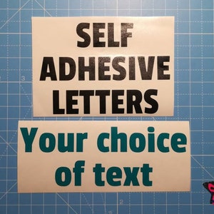 May include: Two white rectangular stickers with black and teal text. The top sticker reads "SELF ADHESIVE LETTERS". The bottom sticker says "Your choice of text". A small, colourful star is in the corner.