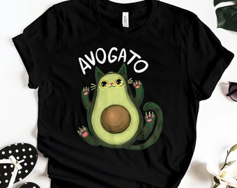 May include: Black t-shirt with a white graphic of an avocado shaped cat with the text "AVOGATO" above it.