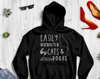 May include: Black hoodie with a white graphic that says "Easily Distracted by Cats & Books" with a black cat and an open book illustration.