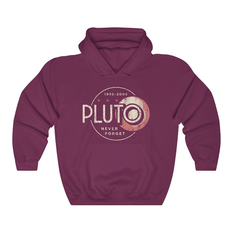 May include: A maroon hooded sweatshirt with a vintage-style graphic of Pluto, a planet that was reclassified as a dwarf planet in 2006. The graphic includes the text "Pluto" in a white circle with the text "1930-2005" above it and "Never Forget" below it.
