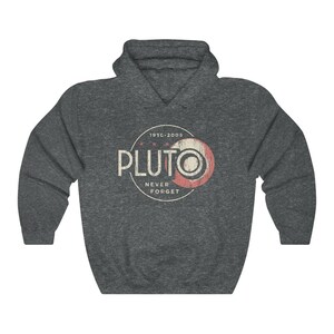 May include: A dark grey hooded sweatshirt with a distressed vintage-style graphic of Pluto, a planet, with the text "1930-2005 Pluto Never Forget".