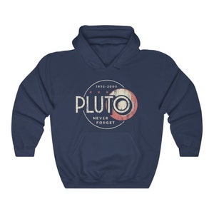 May include: A navy blue hooded sweatshirt with a vintage-style graphic of Pluto, a planet that was reclassified as a dwarf planet in 2006. The graphic includes the text "Pluto" in white, "1930-2005" in black, and "Never Forget" in white.