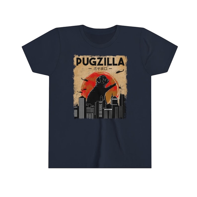 May include: A navy blue t-shirt with a vintage-style graphic of a pug standing on a city skyline. The graphic says "Pugzilla -  パグジラ - ".