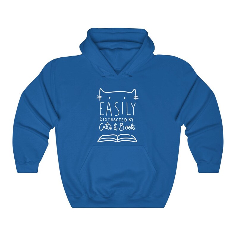 May include: A royal blue hooded sweatshirt with a white graphic design that says "Easily Distracted by Cats & Books" with a cat head and an open book.
