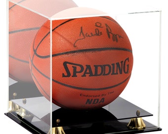 May include: A signed Spalding basketball in a clear acrylic display case with a black base and gold feet. The basketball is orange and brown with black stitching and the text "SPALDING" and "Endorsed By The NBA".