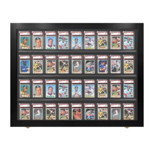 May include: Black wooden display case with 36 clear plastic slots for holding baseball cards. The case has two rows of 18 slots each. The cards are visible through the clear plastic.