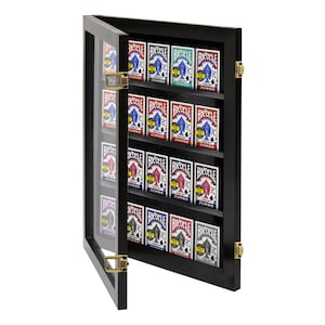 May include: A black wooden display case with glass doors, holding a collection of playing cards. The case has 12 shelves and is designed to store and display multiple decks of cards. The case has gold hinges and a glass door that is open.