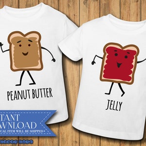 May include: Two white t-shirts with a peanut butter and jelly sandwich design. The peanut butter sandwich has a brown face and the jelly sandwich has a red face. The text "Peanut Butter" and "Jelly" is printed on the shirts.